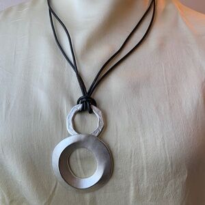 Necklace with a silver coloured pendant